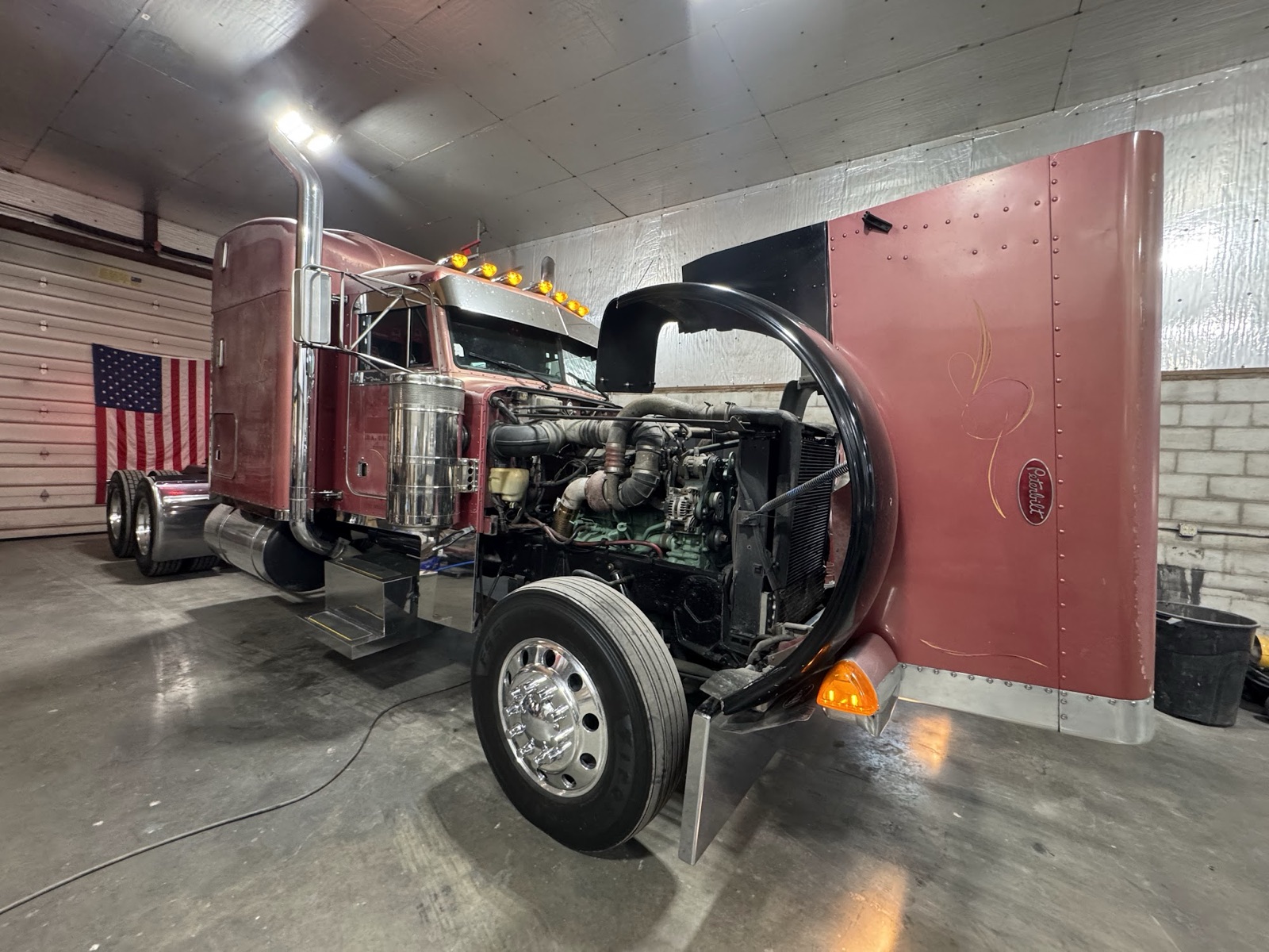 Peterbilt in the shop with American flag