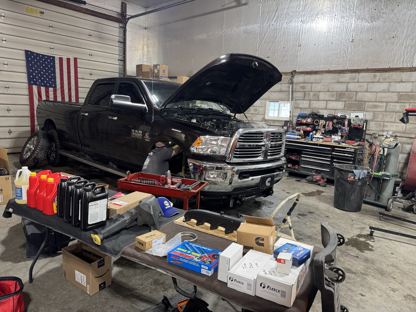 Ram 2500 in the shop with parts laid out for install